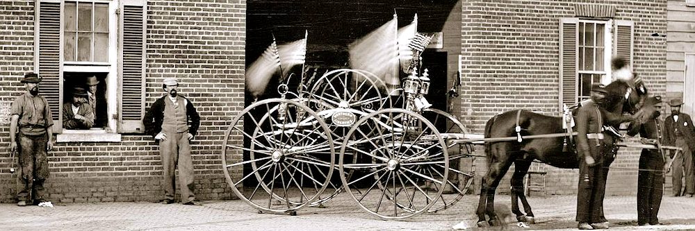 Proud workers on left with the carriage they repaired.