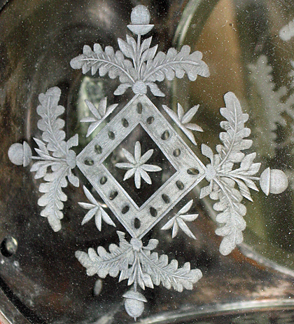 Oak and acorn pattern on cut glass lantern.