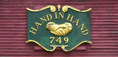 Hand-In-Hand sign on restoration shop.