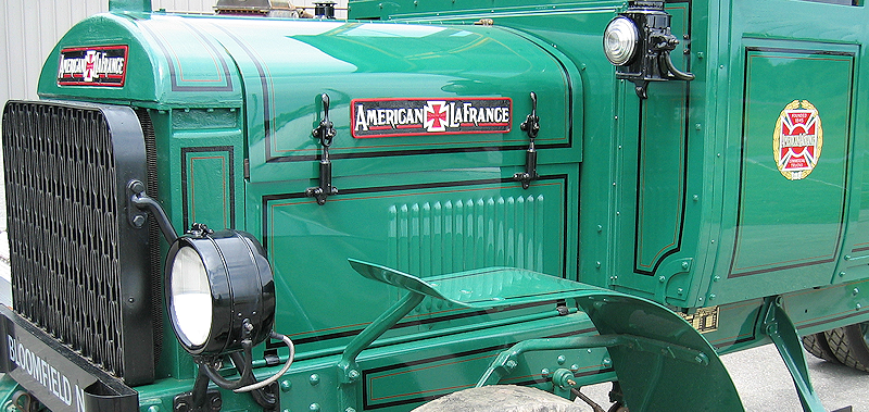 Black stripes and red lines on green American LaFrance commercial truck restoration