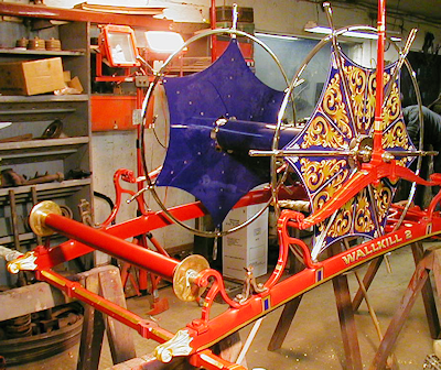 1880s Silsby hose carriage in Firefly Restoration shop with spool decorated by Ken Soderbeck